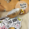 25 Assorted Bee Stickers: Decorate laptops, water bottles, journals, and more with these vibrant and unique bee stickers.
Queen Bee Spoon: This elegant spoon features a stunning queen bee design and a long handle for easy stirring.
Bee Print Vinyl Cosmetic Bag: Stylish and functional, this bag is perfect for storing makeup, toiletries, or other essentials.
Bee Pill Carrier Compact: Keep your medications organized and easily accessible with this convenient and discreet pill carrier.
Handmade Queen Bee Magnet