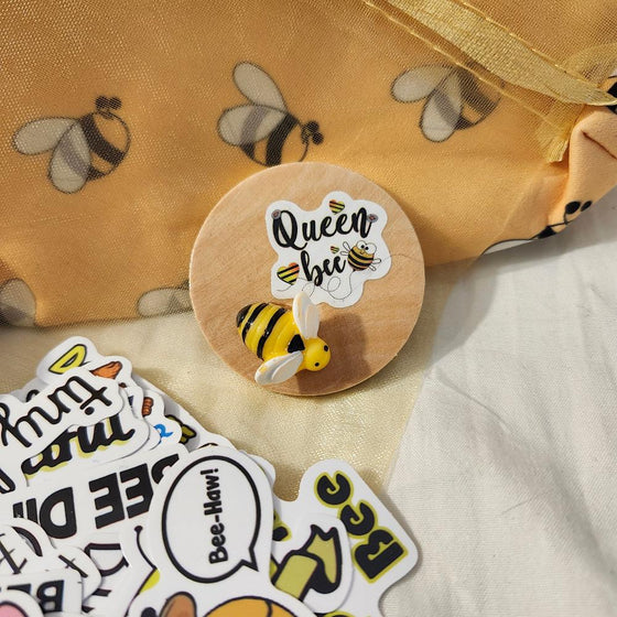 25 Assorted Bee Stickers: Decorate laptops, water bottles, journals, and more with these vibrant and unique bee stickers.
Queen Bee Spoon: This elegant spoon features a stunning queen bee design and a long handle for easy stirring.
Bee Print Vinyl Cosmetic Bag: Stylish and functional, this bag is perfect for storing makeup, toiletries, or other essentials.
Bee Pill Carrier Compact: Keep your medications organized and easily accessible with this convenient and discreet pill carrier.
Handmade Queen Bee Magnet